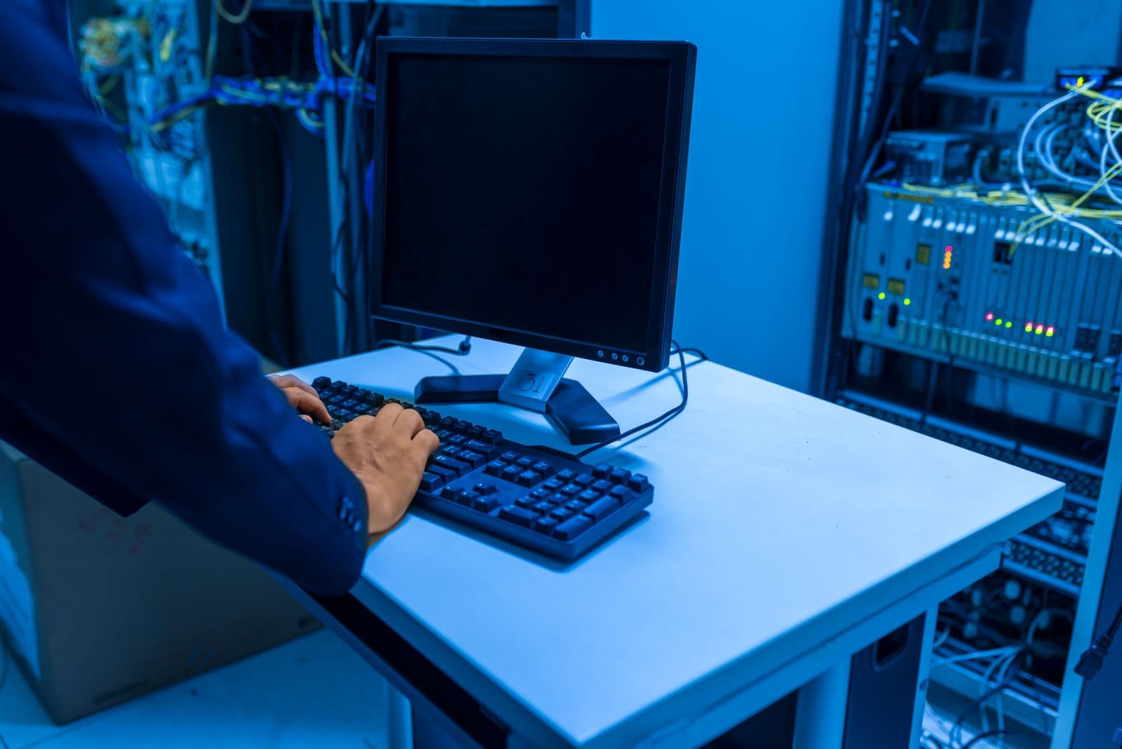 IT professional monitoring systems in a server room
